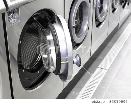 Industrial washing machines in a public laundromat Industrial washing machines in a public laundromat 86359695
