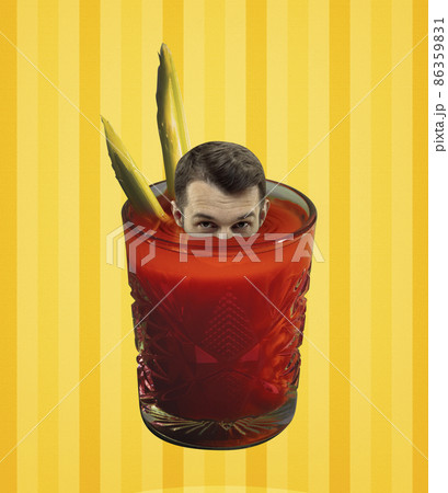 Young man's head peeking out of glass with bloody mary cocktail isolated on light yellow background. Pop art, retro style. Concept of drinks, taste, party. 86359831