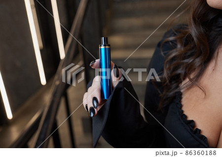 disposable electronic cigarettes in hand. The concept of modern smoking, vaping and nicotine. 86360188