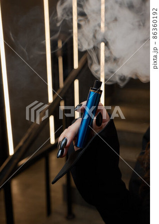 disposable electronic cigarettes in hand. The concept of modern smoking, vaping and nicotine. disposable electronic cigarettes in hand. The concept of modern smoking, vaping and nicotine. 86360192