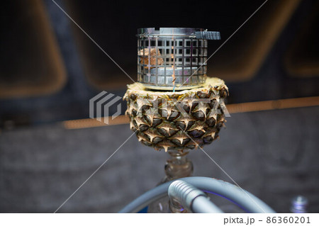 Stylish hookah with the aroma pineapple for relax.Pineapple shisha.Hookah lounge. Stylish hookah with the aroma pineapple for relax.Pineapple shisha.Hookah lounge. 86360201
