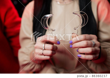 Nurse holding a dental retractor in her hands. Dental Cheek Retractor close-up in hands. Lip Retractors. Nurse holding a dental retractor in her hands. Dental Cheek Retractor close-up in hands. Lip Retractors. 86360237