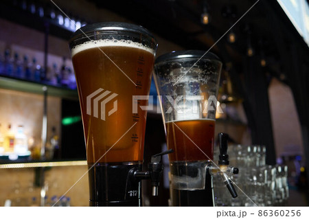 blur background closeup beer tower with bokeh at the night bar. blur background closeup beer tower with bokeh at the night bar. 86360256