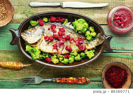 Appetizing gilthead fish in berry sauce. 86360771