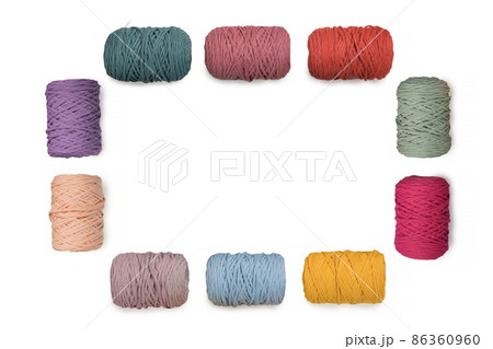 Frame of colorful macrame yarns isolated on white background. Natural cotton macrame yarn rolls on white 86360960