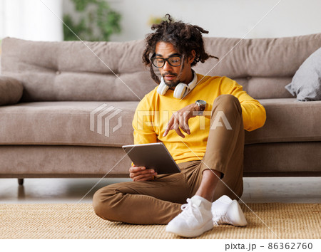 Young african american man with digital tablet and talking via video call during self-isolation 86362760