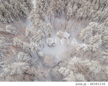 Aerial view of a winter snow-covered pine forest. Winter forest texture. Aerial view. Aerial drone view of a winter landscape. Snow covered forest. Aerial photography Aerial view of a winter snow-covered pine forest. Winter forest texture. Aerial view. Aerial drone view of a winter landscape. Snow covered forest. Aerial photography 86363156