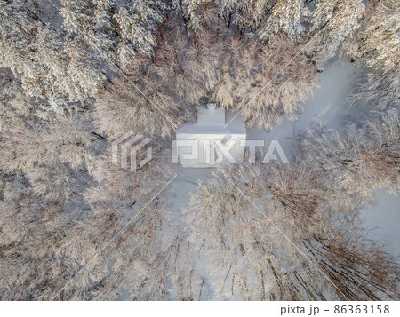 Aerial view of a winter snow-covered pine forest. Winter forest texture. Aerial view. Aerial drone view of a winter landscape. Snow covered forest. Aerial photography Aerial view of a winter snow-covered pine forest. Winter forest texture. Aerial view. Aerial drone view of a winter landscape. Snow covered forest. Aerial photography 86363158