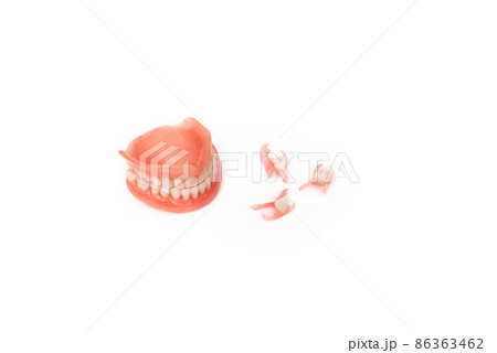 Dentures on a white background. Close-up of dentures. Dentistry is conceptual photography. Prosthetic dentistry. False teeth. Prosthetics. Close-up of plastic denture teeth isolate no fond background Dentures on a white background. Close-up of dentures. Dentistry is conceptual photography. Prosthetic dentistry. False teeth. Prosthetics. Close-up of plastic denture teeth isolate no fond background 86363462