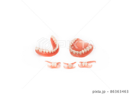 Dentures on a white background. Close-up of dentures. Full removable plastic denture of the jaws. Prosthetic dentistry. False teeth. Close-up of plastic dentures. Teeth on a white background 86363463