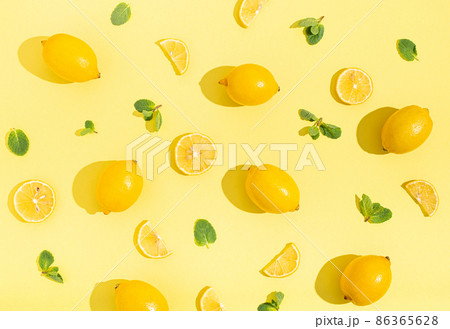 lemons with mint on minimal beige yellow background on bright sun light with hard shadows pattern 86365628