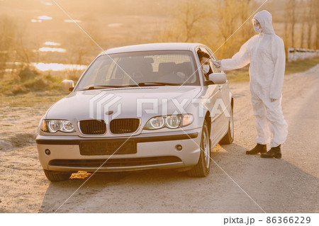 Person in a protective suit checks the temperature 86366229