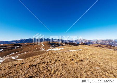 Lessinia Plateau with the Mountain Range of Monte Baldo and Adamello Brenta Lessinia Plateau with the Mountain Range of Monte Baldo and Adamello Brenta 86368457