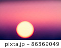 Blurred magenta and purple colored sunset through metal bars 86369049