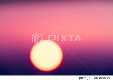 Blurred magenta and purple colored sunset through metal bars 86369049