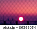 Blurred magenta and purple colored sunset through metal bars 86369054