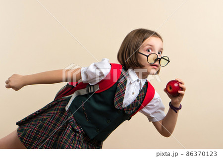 Girl in school uniform with red apple 86370123