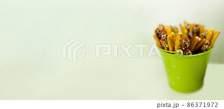 green bucket with sweets 86371972