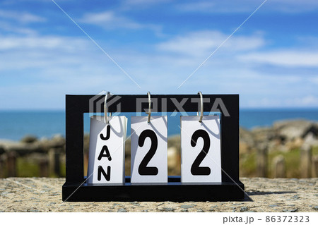 Jan 22 calendar date text on wooden frame with blurred background of ocean 86372323