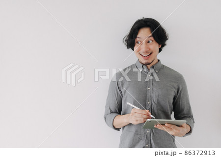 Happy wow face businessman use digital tablet and advertisement space. Happy wow face businessman use digital tablet and advertisement space. 86372913