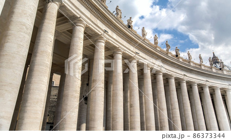 Vatican city, Vatican - February 2015: Architectural details of St. Peter's Basilica, historic columns with statues. Vatican city, Vatican - February 2015: Architectural details of St. Peter's Basilica, historic columns with statues. 86373344