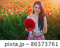 beautiful girl in a poppy field at sunset 86373761