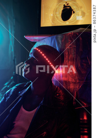 Happy young African man with illumination around his head 86374387
