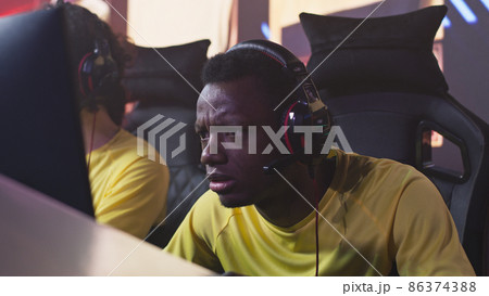 Focused male gamer taking part in gaming tournament 86374388
