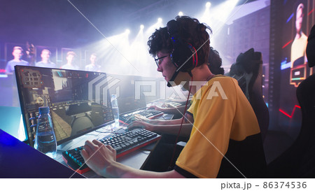 Teen gamer playing shooter with team 86374536