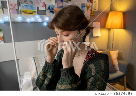 Young woman breathing with oxygen tube Young woman breathing with oxygen tube 86374598