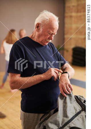 Man checking the indicators on fitness bracelet Man checking the indicators on fitness bracelet 86374615