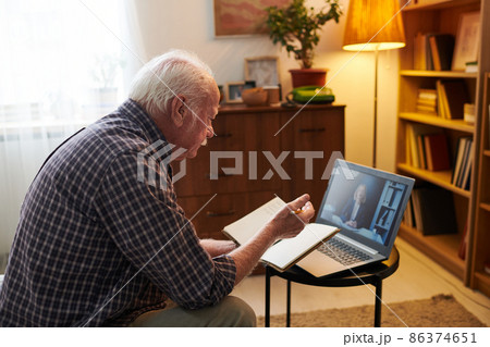 Old man having online consultation on laptop Old man having online consultation on laptop 86374651
