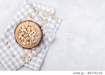 Cicerchia or indian pea on a ceramic bowl with napkin on grey table background, close up, gluten free food 86376150