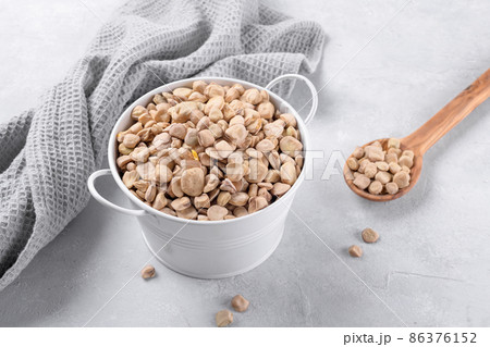 Cicerchia or indian pea in a white bowl with napkin on grey table background, gluten free food, close up 86376152