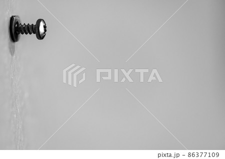 Selective focus on a typical drywall anchor installation . 86377109