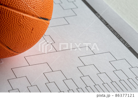 Blank bracket grid on white paper with basketball on top 86377121