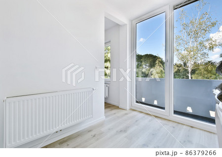 Stylish light corridor with a glass door with a white frame 86379266