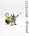 Plastic soldier with American dollars behind him. 86379571