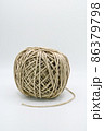 Roll of natural brown decorative string. 86379798