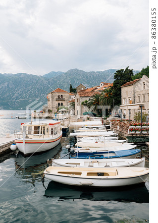 Boat dock with fences off the coast of Perast. Montenegro Boat dock with fences off the coast of Perast. Montenegro 86380155