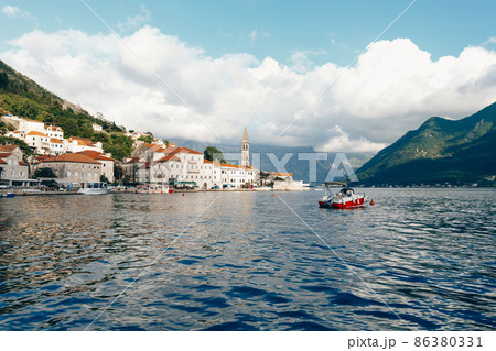 Stone houses with tiled roofs on the Perast embankment. Montenegro 86380331