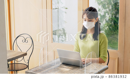 カフェでマスクをして仕事をする女性 カフェでマスクをして仕事をする女性 86381932