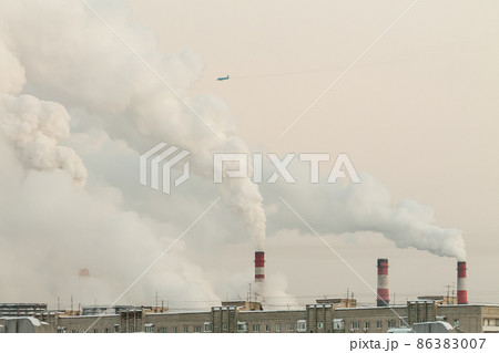 industrial chimneys with heavy white smoke causing air pollution problem 86383007