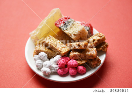 Chinese desserts, Snack mix nuts candies sweets sugar sliced nuts sesame seeds coated beans grains puffed rice candied winter melon, Thai and chinese pay respect to god in chinese new year festival 86386612