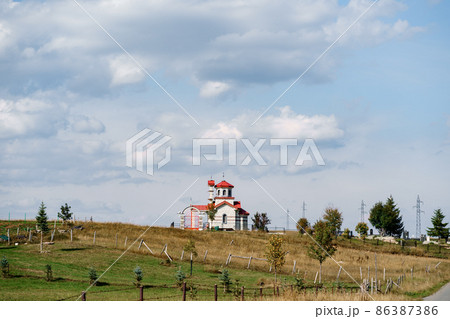 White brick church with red roof in the field White brick church with red roof in the field 86387386