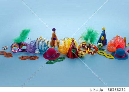 Birthday or carnival background with party items on blue background Birthday or carnival background with party items on blue background 86388232