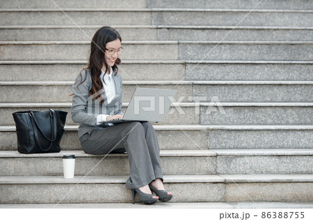 Elegant Businesswoman Working on Laptop 86388755