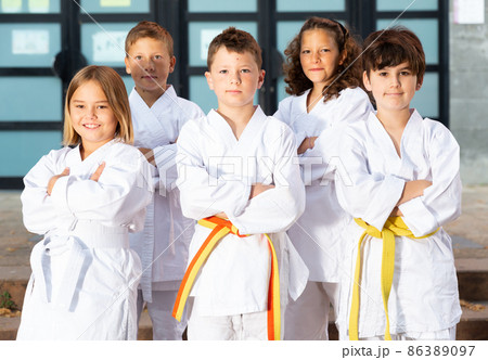 Group of schoolchildren practicing karate at schoolyard 86389097