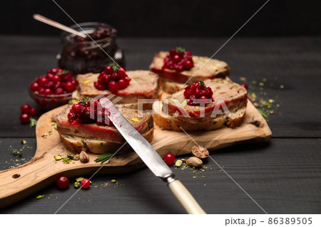 Sliced Traditional French terrine covered with bacon on dark wooden background Sliced Traditional French terrine covered with bacon on dark wooden background 86389505