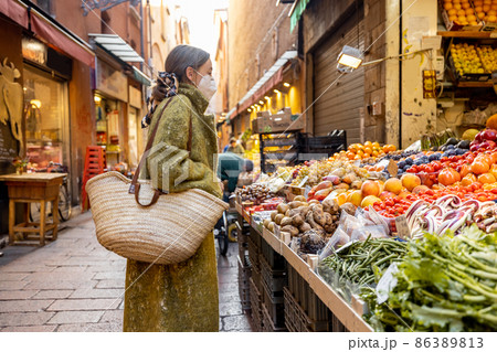 Woman buying food on the street market during pandemic Woman buying food on the street market during pandemic 86389813